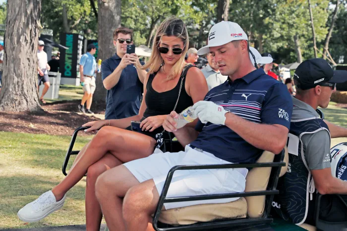 Bryson DeChambeau with his girlfriend leave in a golf cart for the shot gun start during the final round of the LIV Golf Invitational Series Chicago