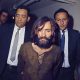 Charles Manson is escorted to his arraignment on conspiracy-murder charges