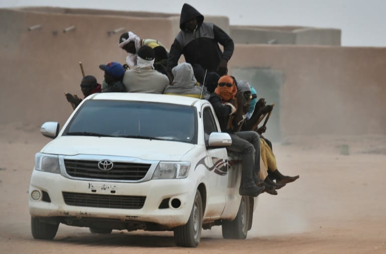 AFP/File / ISSOUF SANOGO A vehicle carrying migrants travels through Agadez, Niger, en route to Libya in June 2015