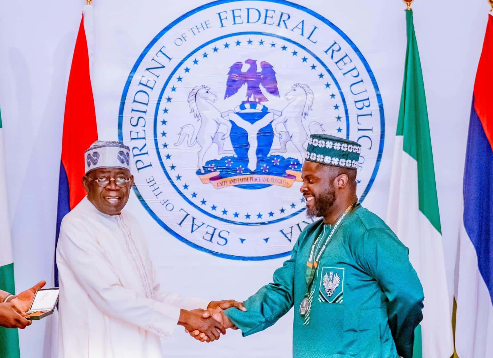 Babafemi Raji shaking hands with President Tinubu 